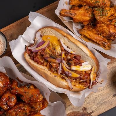 Border Dog served on a board with to servings of chicken wings.