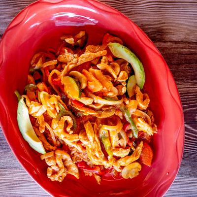 Arroz con pollo served on a red plate.
