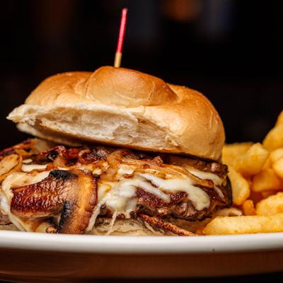 Macedon Burger with grilled onions, mushrooms and mozzarella, served with fries.