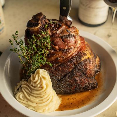 Pork Shank served with whipped potatoes au jus.