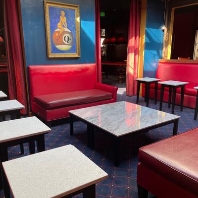 Lounge area, red sofas and marble tables