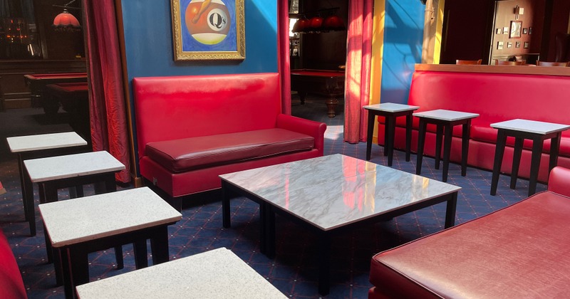 Lounge area, red couches and white marble tables