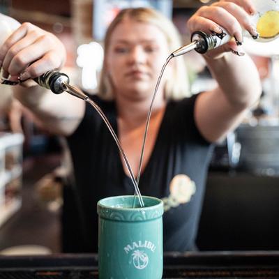 A bartender mixing a drink.