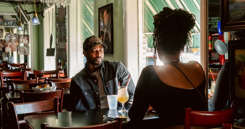 Couple seated at the table with drinks