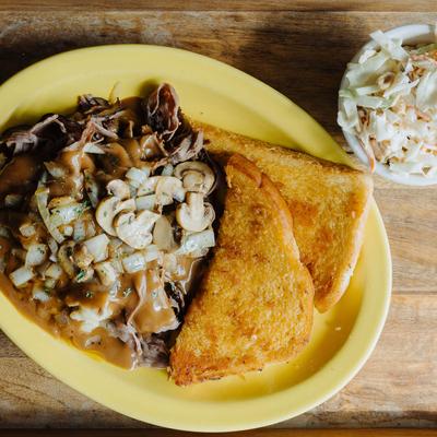 Roast beef, mashed potatoes, gravy, mushrooms, onions, and garlic toast.