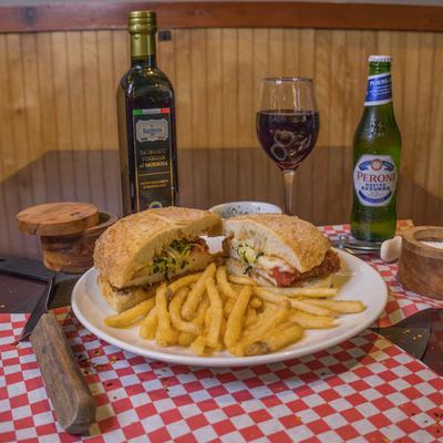 Chicken Parmesan sandwich served with fries, balsamic, beer, and red wine.