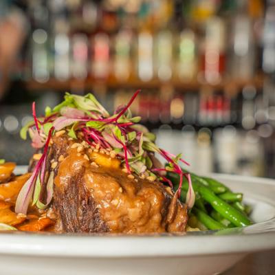 Braised short rib with cheese mashed potatoes, green beans, and microgreens.