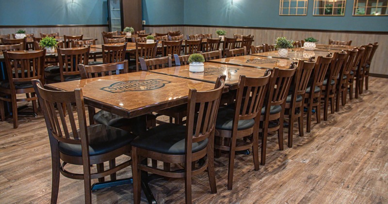 Interior, dining area, long table setups for twenty two people, wooden chairs