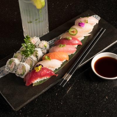Sushi Dinner served on a table with a drink.