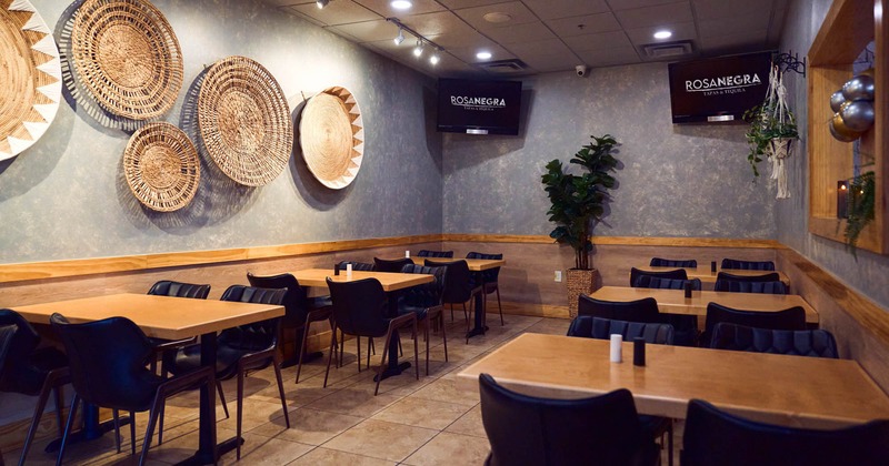 Seating area with two TV screens on the wall