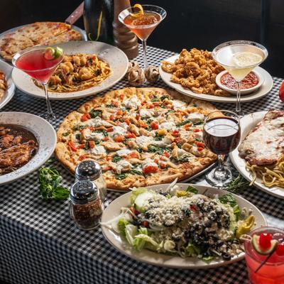 Variety of dishes and drinks spread on a checkered table.