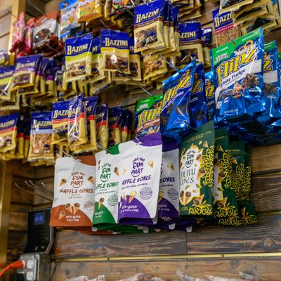 Assorted pet products stocked on a wooden wall display.