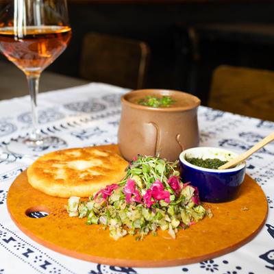 Beanpot dish with pickled veggies on a blue and white traditional Georgian tablecloth