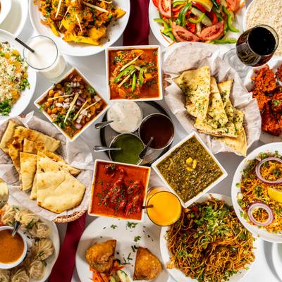 Assorted food dishes and drinks displayed on a table, overhead view.