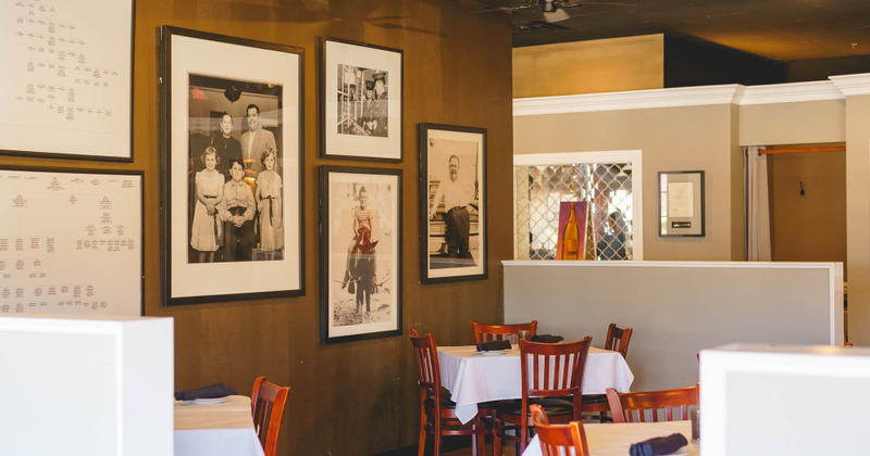 Interior, dining area with framed old photos on walls