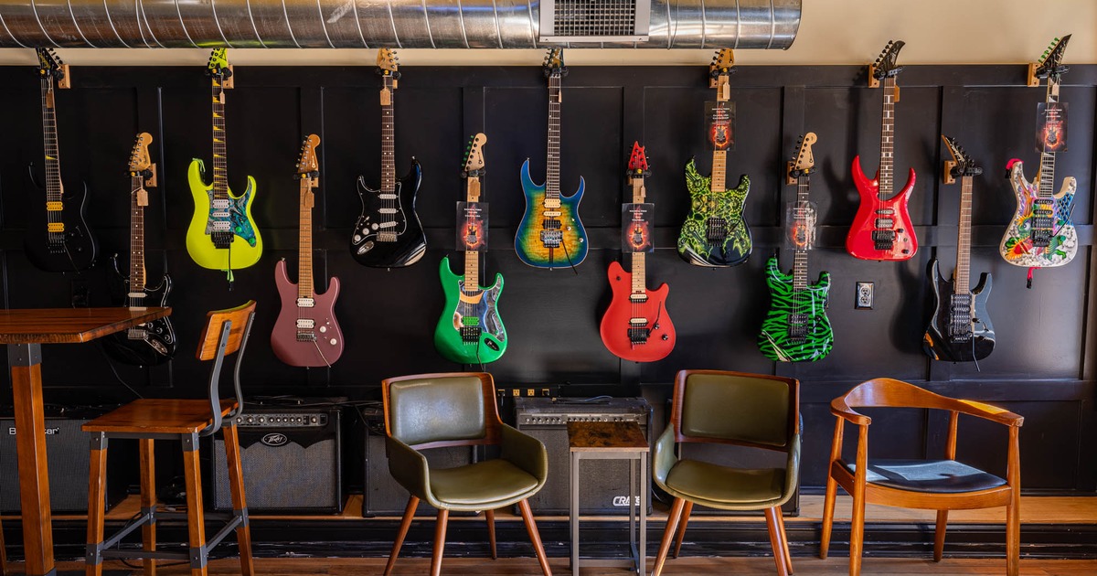 Inside, seating area with guitars on the wall