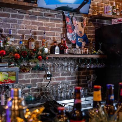 Bar area, shelves with drinks.