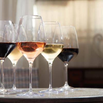 Elegant glasses filled with different types of wine arranged neatly on a table.