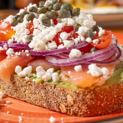 Toasted topped with goat cheese, smoked salmon, avocado, tomato, red onions, and capers.