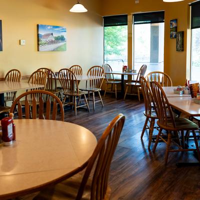Diner area, tables and chairs, wide view.
