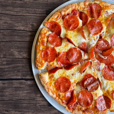 Pizza with pepperoni topping and hot honey drizzle.