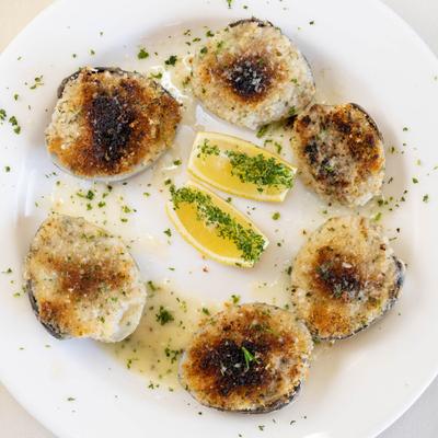 Oven baked clams topped with seasoned breadcrumbs.