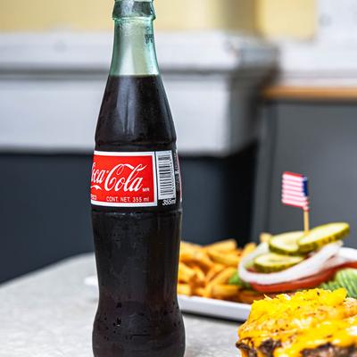 A cold bottle of coca cola.