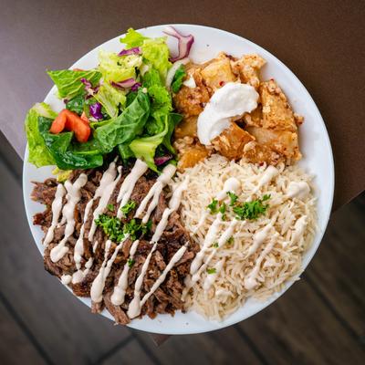 Beef Shawarma with tahini, served with rice, salad, and spicy garlic potatoes.