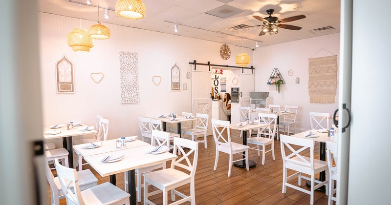 Interior, dining area with white tables and chairs