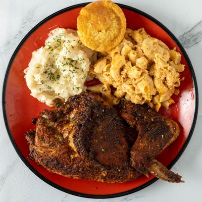 Baked chicken breast and wing, side mac and cheese, mashed potatoes and cornbread.
