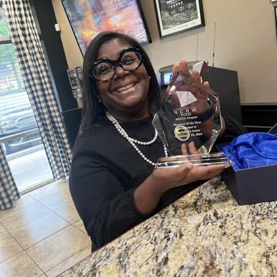 The owner holding an award.