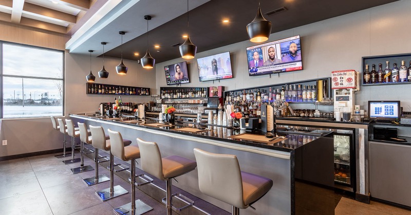 Interior, counter bar and lined-up bar stools
