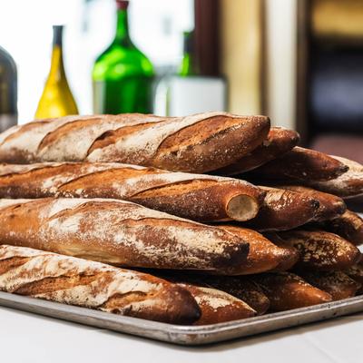 Stacked baguettes on a tray.