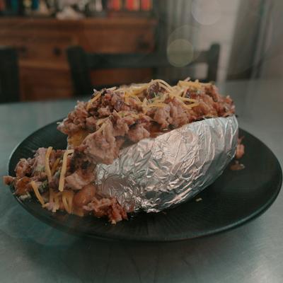 Loaded baked potato with various toppings.