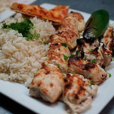 Grilled chicken skewers, with rice.
