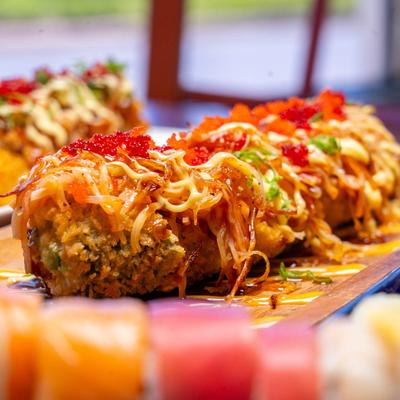 Crispy sushi rolls topped with roe, spicy mayo, and green onions.