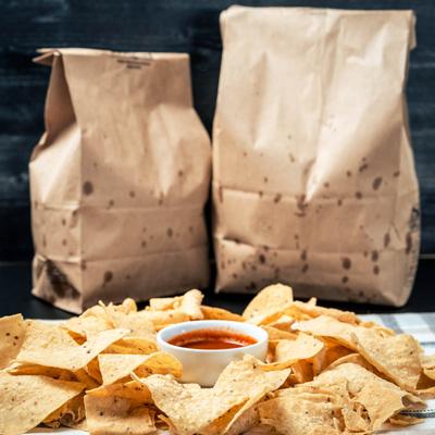 Tortilla chips with red sauce for dipping.