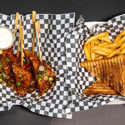 Szechuan Paneer Sticks and a grilled sandwich with fries.