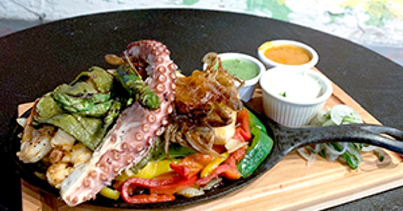 Octopus meat, mixed vegetables and three dips on the side
