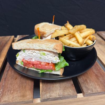 Chicken salad sandwich with French fries.