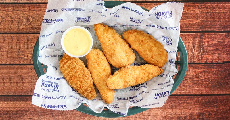 Chicken tenders served with a sauce for dipping