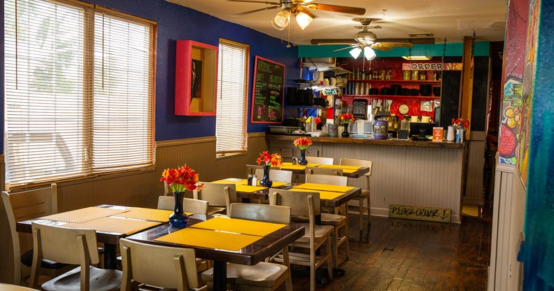 Interior, order counter and tables decorated with flower vases