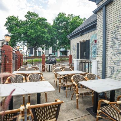 Outdoor seating area with tables and chairs.