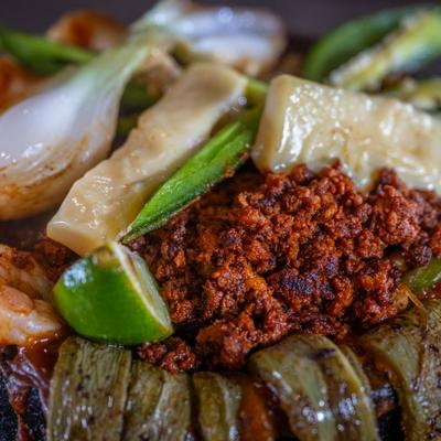 Molcajete with chorizo, close-up.