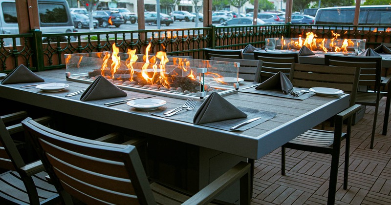 Seating area with fire pits on set dining tables