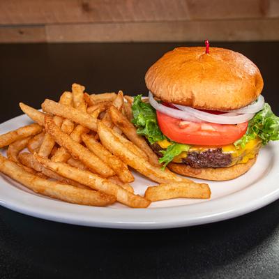 Classic burger served with fries on a white plate.