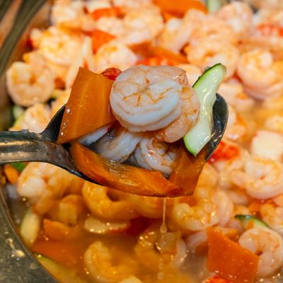 Seafood with mixed vegetables in a buffet tray.