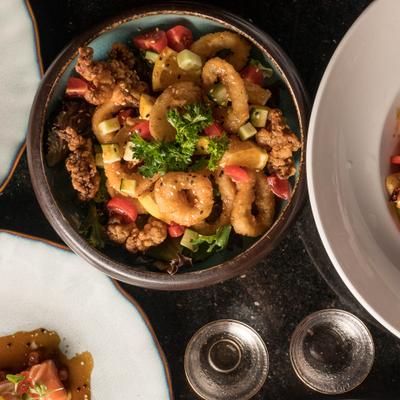 Crispy calamari served with other dishes on the table.