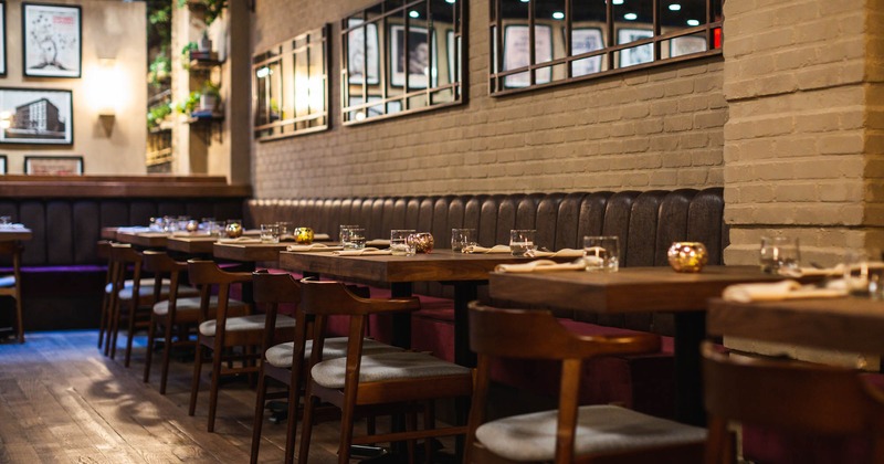 Interior, tables, chairs, booths, decorative mirrors, paintings, empty glasses