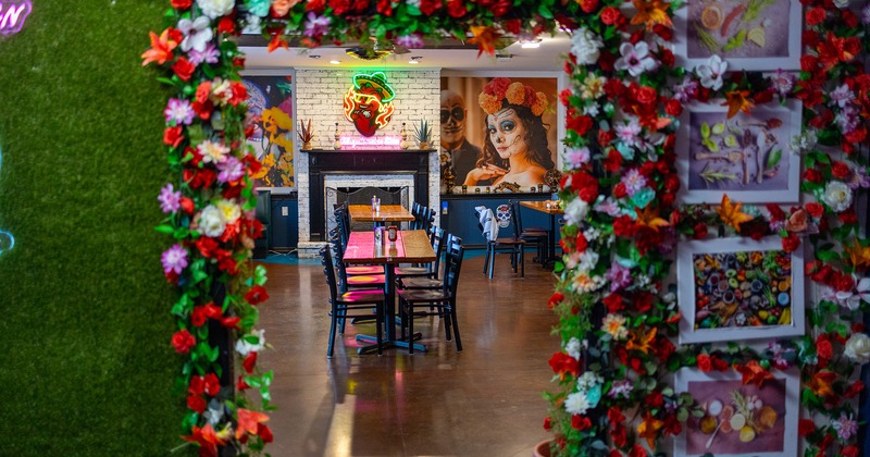 Interior, view to the dining area through the door decorated with flowers